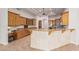 Modern kitchen showcasing wooden cabinets, granite countertops, and an eat-in bar at 3954 E Florian Ave, Mesa, AZ 85206