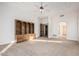 Spacious living room features neutral carpet, ceiling fan, and custom wood shelving at 3954 E Florian Ave, Mesa, AZ 85206