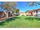 Backyard with artificial grass, a storage shed, a pergola, and outdoor furniture at 40716 N Hudson Trl, Anthem, AZ 85086