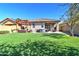 Backyard with an outdoor kitchen, a patio area, artificial turf, and a pergola at 40716 N Hudson Trl, Anthem, AZ 85086