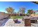 Spacious backyard showcasing a fire pit, hot tub, and well-maintained landscaping at 40716 N Hudson Trl, Anthem, AZ 85086