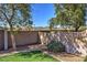 Serene backyard view with lush green grass, mature trees, and a stone-lined landscape at 40716 N Hudson Trl, Anthem, AZ 85086