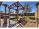 Inviting backyard patio featuring a pergola with comfortable seating and a cozy heater at 40716 N Hudson Trl, Anthem, AZ 85086