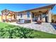 Outdoor patio area with a built-in hot tub, grill, pergola and artificial turf at 40716 N Hudson Trl, Anthem, AZ 85086