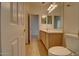 Bathroom featuring a light wood vanity and ample lighting for a bright, inviting feel at 40716 N Hudson Trl, Anthem, AZ 85086