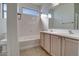 Clean bathroom features a tub-shower combination, tile floors, and a double sink vanity at 40716 N Hudson Trl, Anthem, AZ 85086