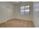 This bright bedroom boasts a window, closet and plush carpet for comfort and functionality at 40716 N Hudson Trl, Anthem, AZ 85086