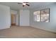 Open bedroom featuring carpet, a ceiling fan, and an entrance to a secondary room at 40716 N Hudson Trl, Anthem, AZ 85086