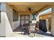 Cozy covered patio area featuring a ceiling fan, dining set, and grill at 40716 N Hudson Trl, Anthem, AZ 85086