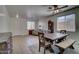 Open dining room with a rustic wood table, bench seating, and a charming grandfather clock at 40716 N Hudson Trl, Anthem, AZ 85086