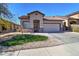 Charming single-story home featuring a well-manicured lawn and a two-car garage on a sunny day at 40716 N Hudson Trl, Anthem, AZ 85086