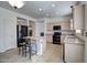 Spacious kitchen with a large center island, sleek black appliances, neutral cabinetry, and tile floors at 40716 N Hudson Trl, Anthem, AZ 85086