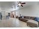 Bright living area connected to the kitchen featuring comfortable seating and tile floors at 40716 N Hudson Trl, Anthem, AZ 85086