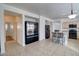 Open-concept living space combining living, dining, and kitchen areas, featuring tile flooring and natural light at 40716 N Hudson Trl, Anthem, AZ 85086