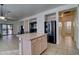 Spacious open-concept living space features tile flooring, with the kitchen seamlessly flowing into the living area at 40716 N Hudson Trl, Anthem, AZ 85086