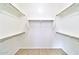 A walk-in closet with built-in shelving offers ample storage in this well-designed space at 40716 N Hudson Trl, Anthem, AZ 85086