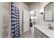 Well-lit bathroom with a shower behind a buffalo check curtain, a vanity sink, and modern fixtures at 4202 E Broadway Rd # 211, Mesa, AZ 85206