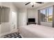 Bright bedroom with ensuite bathroom, a ceiling fan and television, and natural light from the large window at 4202 E Broadway Rd # 211, Mesa, AZ 85206