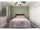 Cozy bedroom featuring a ceiling fan, plush bedding, and ample natural light from the large window at 4202 E Broadway Rd # 211, Mesa, AZ 85206