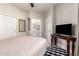 Comfortable bedroom with ensuite bathroom, modern ceiling fan and tv atop a handsome wooden table at 4202 E Broadway Rd # 211, Mesa, AZ 85206