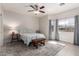 This bedroom features tile floors, a ceiling fan, and neutral walls for a calming retreat at 4202 E Broadway Rd # 211, Mesa, AZ 85206