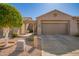 Single story home with a front-facing two car garage, desert landscaping, and an arched entryway at 4202 E Broadway Rd # 211, Mesa, AZ 85206