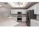 Kitchen featuring stainless steel appliances, light-colored cabinetry, a farm sink, and beautiful stone countertops at 4202 E Broadway Rd # 211, Mesa, AZ 85206