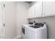 Efficient laundry room with modern front-load washer and dryer, ample cabinet storage, and clean design at 4202 E Broadway Rd # 211, Mesa, AZ 85206