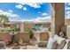 Comfortable patio seating with a view of a pool and meticulously landscaped backyard under a blue sky at 4202 E Broadway Rd # 211, Mesa, AZ 85206