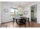 Chic dining room with a round table, black chairs, and a modern chandelier, perfect for Gathering gatherings at 4226 E Marlene Dr, Gilbert, AZ 85296