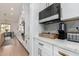 Modern kitchen with sleek white cabinets, a microwave, and marble countertops at 4226 E Marlene Dr, Gilbert, AZ 85296