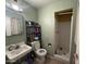 Bathroom with a white tiled shower, shelf for storage, and tile flooring at 451 E Franklin Ave, Mesa, AZ 85204