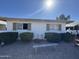 View of the front yard, gravel, seating, and single story structure with awnings at 451 E Franklin Ave, Mesa, AZ 85204