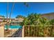 Balcony view showcasing the community pool surrounded by lush greenery and palm trees at 520 W Clarendon Ave # E18, Phoenix, AZ 85013