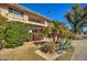 Attractive exterior view of a multi-story building surrounded by mature trees and landscaping at 520 W Clarendon Ave # E18, Phoenix, AZ 85013