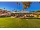 Exterior shot of a community outdoor space with seating areas and manicured lawn at 520 W Clarendon Ave # E18, Phoenix, AZ 85013