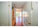 Bright hallway features hardwood floors and built-in storage, leading to a bright living area at 520 W Clarendon Ave # E18, Phoenix, AZ 85013