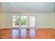 Bright living room with hardwood floors, shutters, and access to a balcony at 520 W Clarendon Ave # E18, Phoenix, AZ 85013