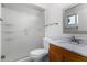 Bathroom features glass door shower, wood vanity, and granite countertop sink at 5226 W Freeway Ln, Glendale, AZ 85302