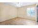 Bedroom with large window, ceiling fan, tile floors, and good lighting at 5226 W Freeway Ln, Glendale, AZ 85302