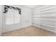 Bedroom with closet shelving, tile floors, and natural light at 5226 W Freeway Ln, Glendale, AZ 85302