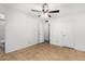 Bedroom with tile flooring, neutral walls, ceiling fan, and bathroom access at 5226 W Freeway Ln, Glendale, AZ 85302