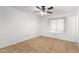 Bright bedroom features tile flooring, ceiling fan, and window for natural light at 5226 W Freeway Ln, Glendale, AZ 85302