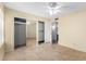 A spacious bedroom with neutral walls, tile flooring, and mirrored closet doors, offering ample storage space at 5226 W Freeway Ln, Glendale, AZ 85302