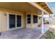 Covered patio with concrete flooring, providing a shaded outdoor living space with backyard access through sliding glass doors at 5226 W Freeway Ln, Glendale, AZ 85302