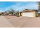 View of the home featuring a front yard and a two-car garage and driveway at 5226 W Freeway Ln, Glendale, AZ 85302