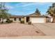 Charming single-story home with low maintenance desert landscaping and a two car garage at 5226 W Freeway Ln, Glendale, AZ 85302