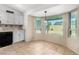 An eat-in kitchen featuring tiled floors, light-colored cabinets and lots of natural light at 5226 W Freeway Ln, Glendale, AZ 85302