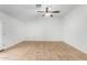 An open-plan living room featuring tiled floors and a ceiling fan with lighting at 5226 W Freeway Ln, Glendale, AZ 85302