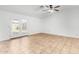 A bright living room featuring tiled floors, a ceiling fan, and access to the backyard at 5226 W Freeway Ln, Glendale, AZ 85302